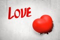 3d close-up rendering of white wall with title `Love`, hole and red valentine heart sitting in hole.