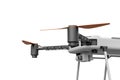 3d close-up side view rendering of part of light gray quadcopter with camera isolated on white background.