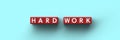 3D Cubes with the words hard work on a blue background