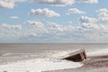 D-day Normandy landings. Coastal landscape with clouds and partially buried WW2 beach defense building.