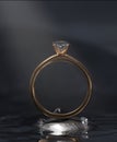 3D design. Gold diamond ring and small diamonds on the rocks in the lake.