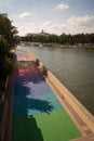 3D drawing of a ship and a boy on a rainbow canvas painted on the Seine embankment in Paris