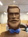 3D figure of a hipster head with a beard and mustache made using laser cutting on wood. 3D mock up of a man portrait