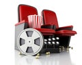 3d Film reel, popcorn and Cinema clapper board on theater seat. Royalty Free Stock Photo
