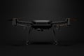 3d front rendering of black drone with camera standing on dark gray gradient background.