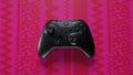 3D game console controller in pink background