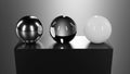 3d glass, chrome and plastic spheres on black plastic pedestal