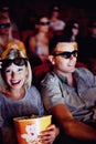 3d glasses, happy couple and popcorn, watching movie or eating on romantic date together. Cinema night, man and woman in Royalty Free Stock Photo