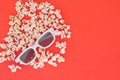 3d glasses and popcorn are isolated on a red background. Flat lay. Copyspace Royalty Free Stock Photo
