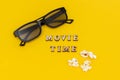 3D glasses, popcorn and text Movie time on yellow paper background. Top view Template Concept cinema movie and entertainment Royalty Free Stock Photo