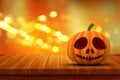 3D Halloween pumpkin on a wooden table with bokeh lights Royalty Free Stock Photo