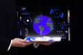 3 d hologram image of the globe on a tablet in human hands on a dark background
