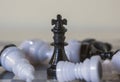 3d icon object of a black standing king chess piece surrounded by fallen pawns. Board games. Chess pieces by importance. Win over