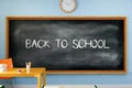 3D illustration. Back to school text written on a blackboard in the classroom. Royalty Free Stock Photo