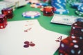 3D illustration casino game. Chips, playing cards for poker. Poker chips, red dice and money on green table. Online