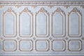 Classic wall of old gold stucco panels blue paint