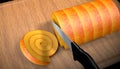 3D illustration cutting a delicious roll cake on the cutting board