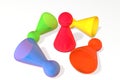 3d illustration: Five colored transparent plastic board game pieces with reflection. The winner and a losers fall and lay isolated Royalty Free Stock Photo