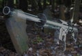 3D illustration of a ghost gun that is an AR-15 ghosted in front of grave markers in an old graveyard