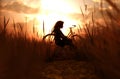 Girl sitting alone in grass field Royalty Free Stock Photo