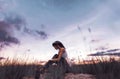 Girl sitting alone in grass field Royalty Free Stock Photo