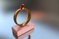 3D illustration of a gold ring with a big red diamond on a pink stand Royalty Free Stock Photo