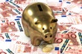 3d illustration: Golden piggy bank with copper coin cents lie on the background of banknote ten Euro, European Union. Money. Royalty Free Stock Photo