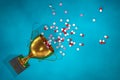3d illustration: Golden winning cup with pills and stimulants tablet thrown on the floor from the pedestal on blue background. Act Royalty Free Stock Photo