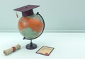 3D Illustration. Graduation cap and diploma with globe.