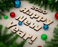 3D illustration 2020 Happy New year greeting card letters made of plywood and Christmas tree branches