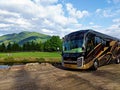 3D illustration of a luxurious Entegra motorhome on the road during a family vacation travel