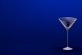 3D illustration of martini glass on blue - mockup with place for your text - drinking glass render Royalty Free Stock Photo
