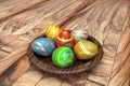 3d illustration of multi-colored easter eggs on a wooden plate and wooden floor