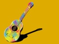 Multi-colored guitar on a yellow background.