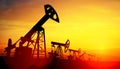 3d illustration of oil pump jacks on sunset background