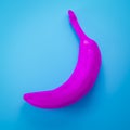 a pink banana on turquoise background