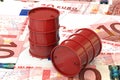 3d illustration: Red barrels of oil lie on the background of banknote of ten Euro, European Union. Money. Petroleum business