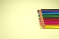 3d illustration. Render of realistic set of color pencils. Crayons on yellow background