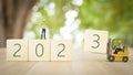 3D illustration. workers are changing year 2023 wooden block on New year and white background