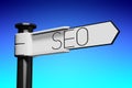 SEO - search engine optimization - white signpost with one arrow, abstract blue background Royalty Free Stock Photo