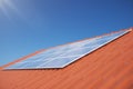 3D illustration solar panels on a red roof of a house. Solar panels with reflection beautiful blue sky. Concept of Royalty Free Stock Photo