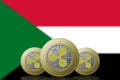 3D ILLUSTRATION Three RIPPLE cryptocurrency with Sudan flag on background