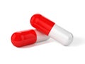 3D Illustration of two capsule pills in red and white colors