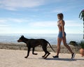 Illustration of a woman walking next to the ocean with her pet dog Royalty Free Stock Photo