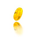 3d illustration of a yellow capsule with a small omega, lying on a white mirror surface with reflection. Banner for Royalty Free Stock Photo