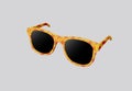 3D illustration yellow fashion sunglasses with red star pattern and black lens optic isolated on gray background Royalty Free Stock Photo