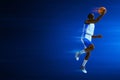 3d illustration young professional basketball player layup on dark blue backgrounds Royalty Free Stock Photo