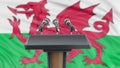 Podium lectern with microphones and Welsh Flag in background