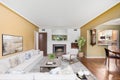 3D interior view of a living room with yellow walls and a wooden floor in a brand-new house