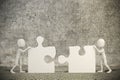 3d man joining two puzzle pieces Royalty Free Stock Photo